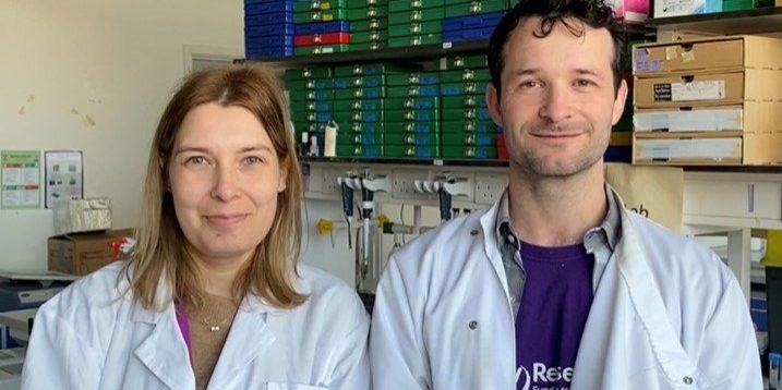 Filipa and Neil 2024 A female and a male researcher wearing white lab coats