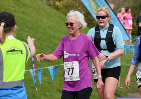 Lady, wearing purple Kidney Research UK t-shirt running