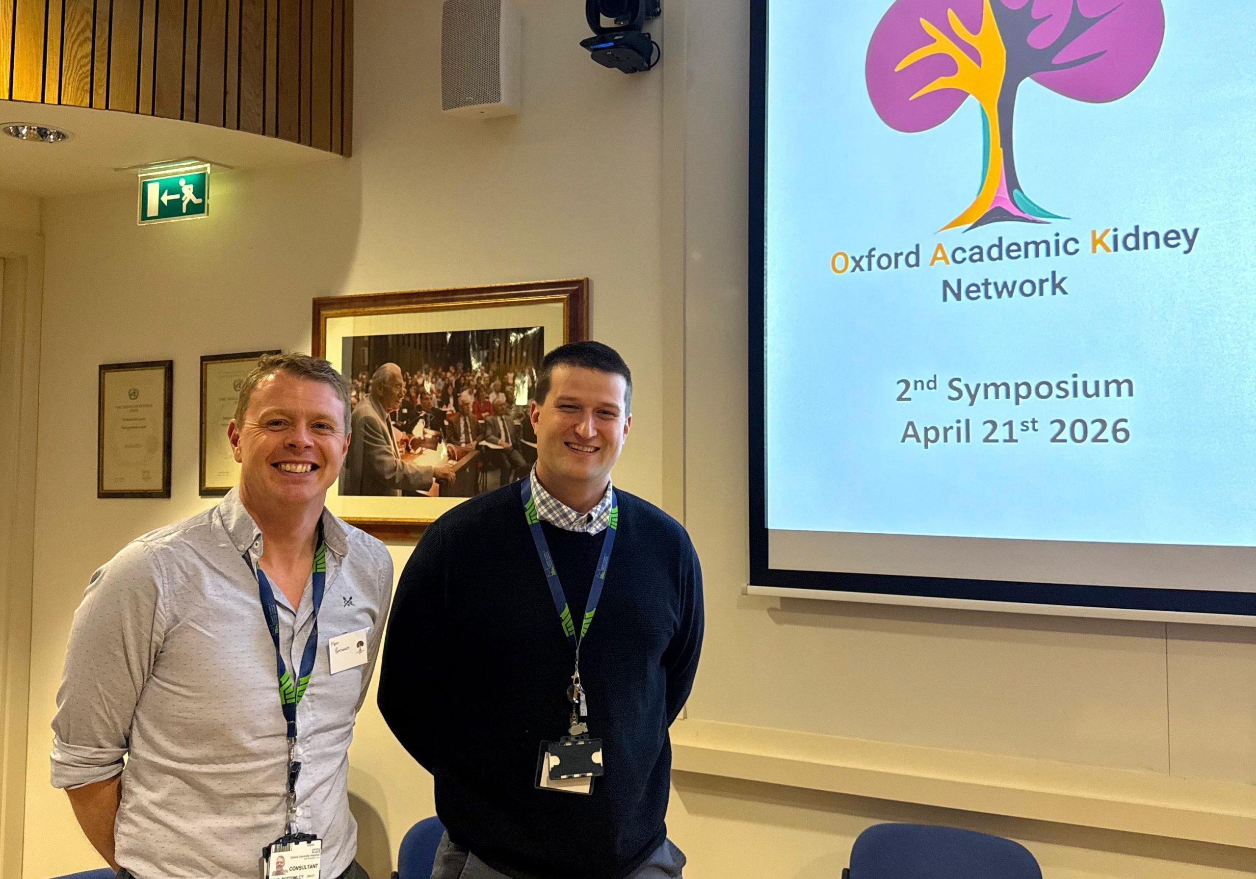 Peter and Matthew, standing side by side, at a presentation