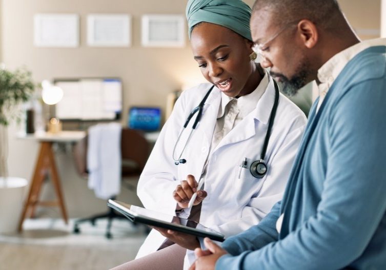 Tablet,,Patient,And,Consultation,With,Doctor,For,Healthcare,,Insurance,Or African male patient and consultation with doctor
